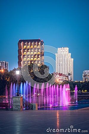 Ð¡olored illuminated fountains and modern buildings in the center of Yekaterinburg city at summer night Editorial Stock Photo